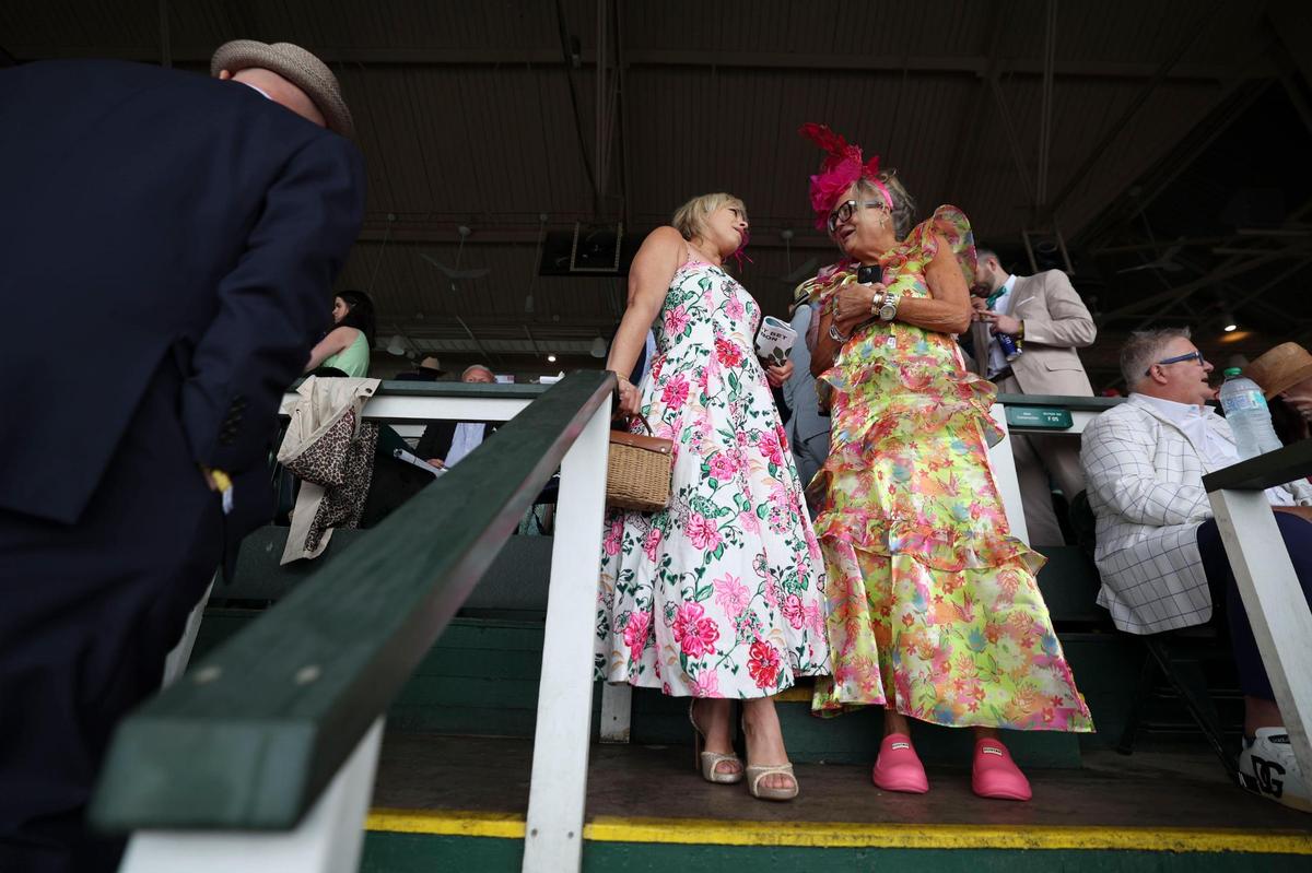 Angie Hays and Kim Davenport wore floral dresses with pink accents during Kentucky Derby 151 at Churchill Downs May 3, 2025.&nbsp;&nbsp;
