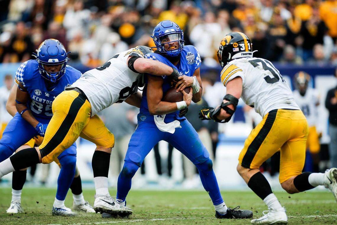 Kentucky Wildcats quarterback Destin Wade (15) is tackled by Iowa Hawkeyes defensive lineman Logan Lee (85) with the ball during the TransPerfect Music City Bowl in Nashville, Tn., Saturday, December 31, 2022.