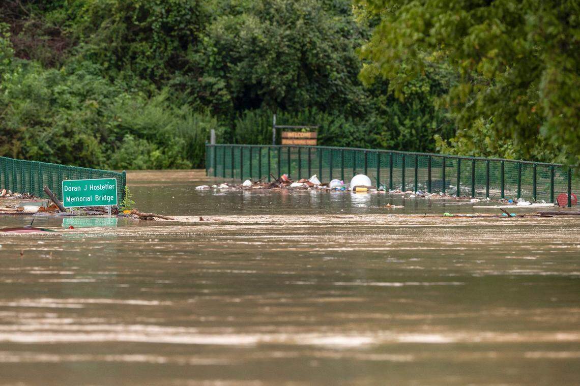 A bridge across the North Fork of the Kentucky River near Lost Creek, Ky., is flooded on Thursday, July 28, 2022. (Ryan C. Hermens/Lexington Herald-Leader via AP)