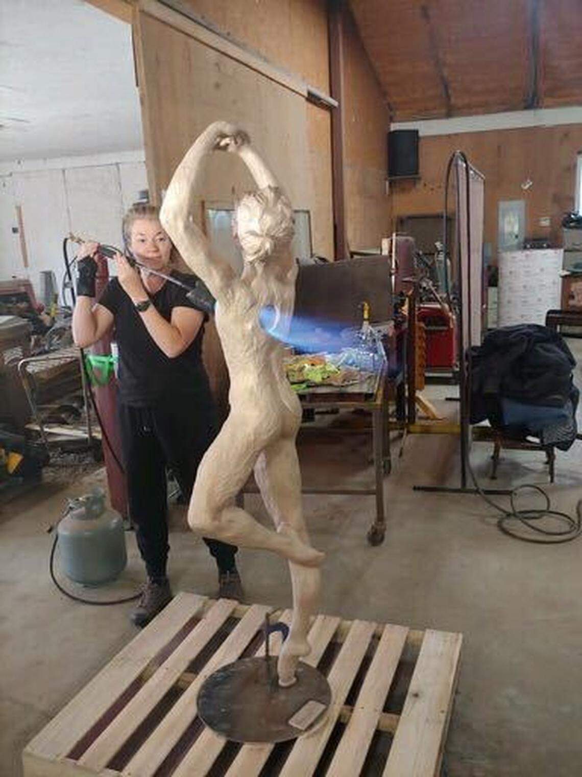 Sculptor Amanda Matthews created holes in each figure where the heart would be to represent feelings of loss. The finished statues have bells inside the holes.