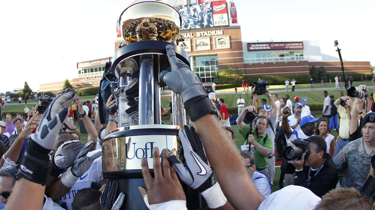 Kentucky team raised the Governor's Cup after Kentucky defeated Louisville 23-16 in Papa Johns Stadium on Sept. 4, 2010. It was the Cats' last victory in the rivalry.    