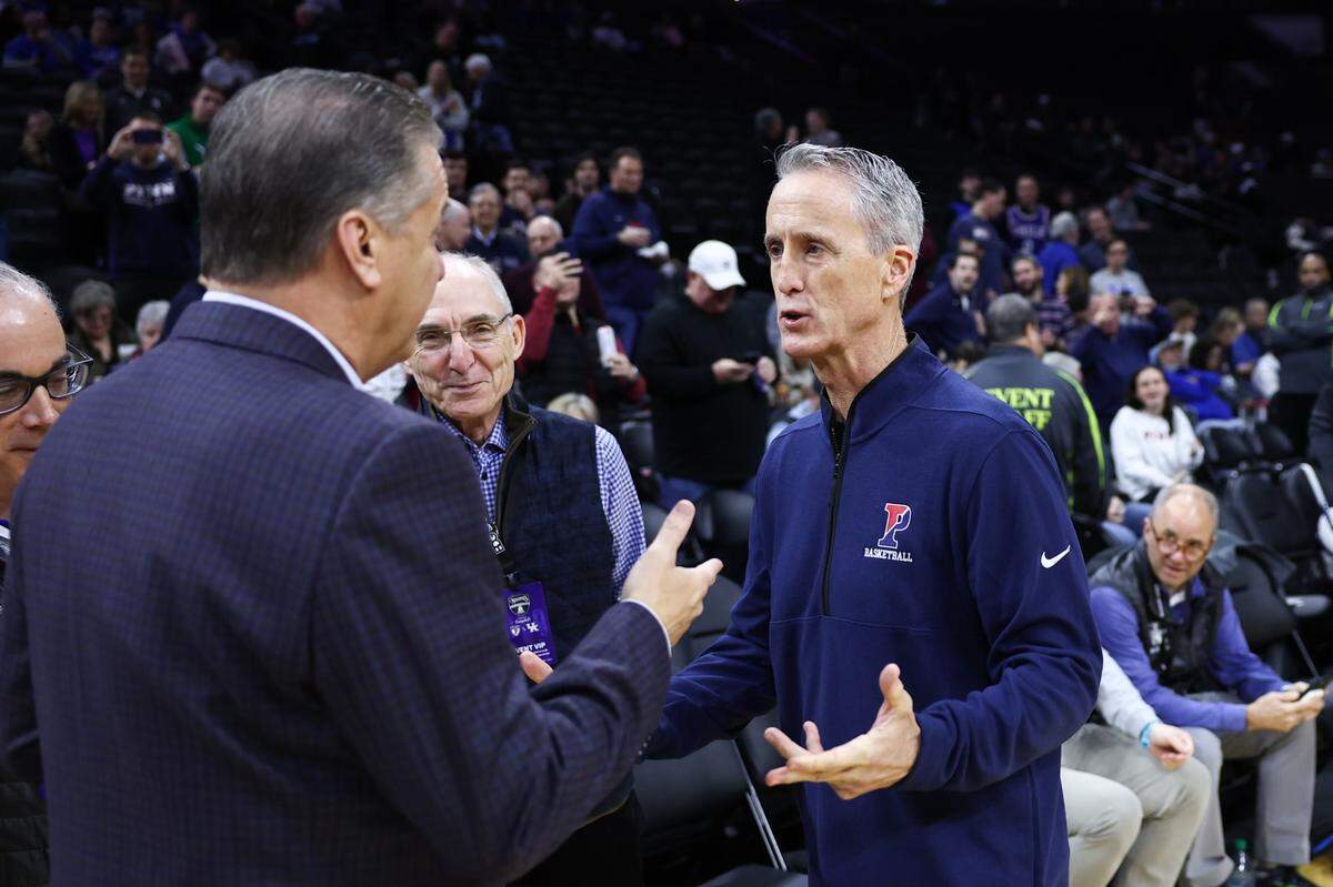 Penn men’s basketball head coach Steve Donahue (right) greets Kentucky head coach John Calipari prior to Saturday’s game at the Wells Fargo Center in Philadelphia.