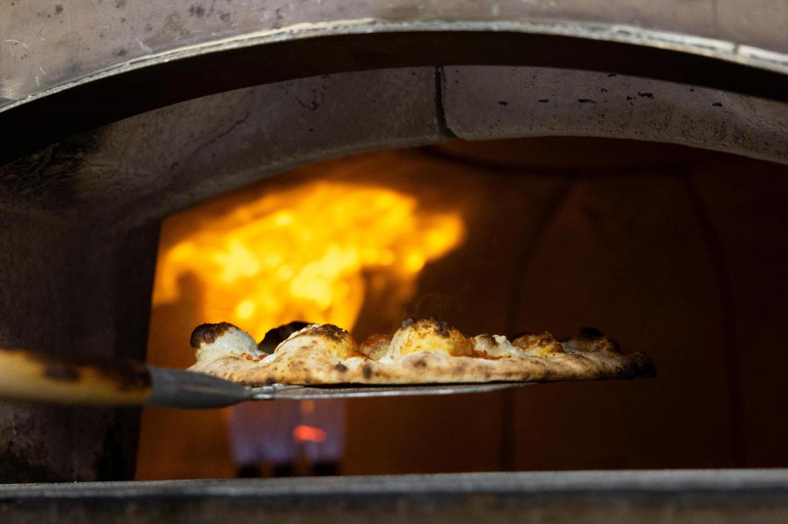 Ethereal Slice House employees prepare old world style pizza a brick style oven with temperatures near 900 degrees in Lexington, Ky.