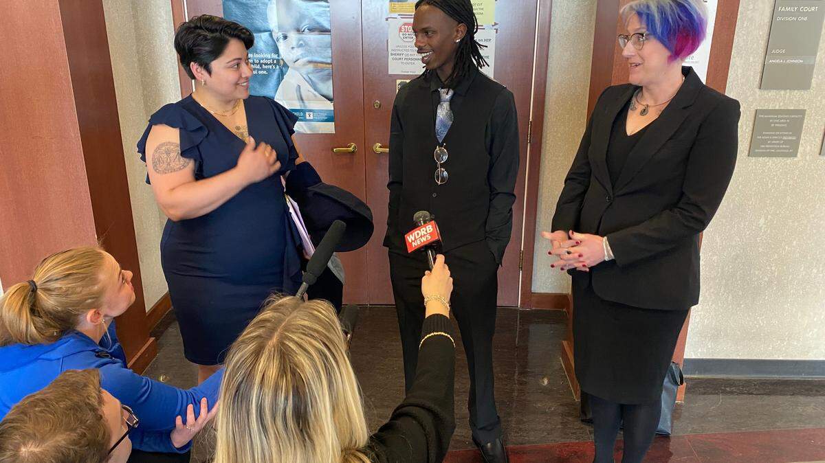 Jonah Bevin, center, stands outside a courtroom in downtown Louisville minutes after a Jefferson Family Court judge upheld and extended an emergency protective order against his adoptive father, former Kentucky Gov. Matt Bevin.