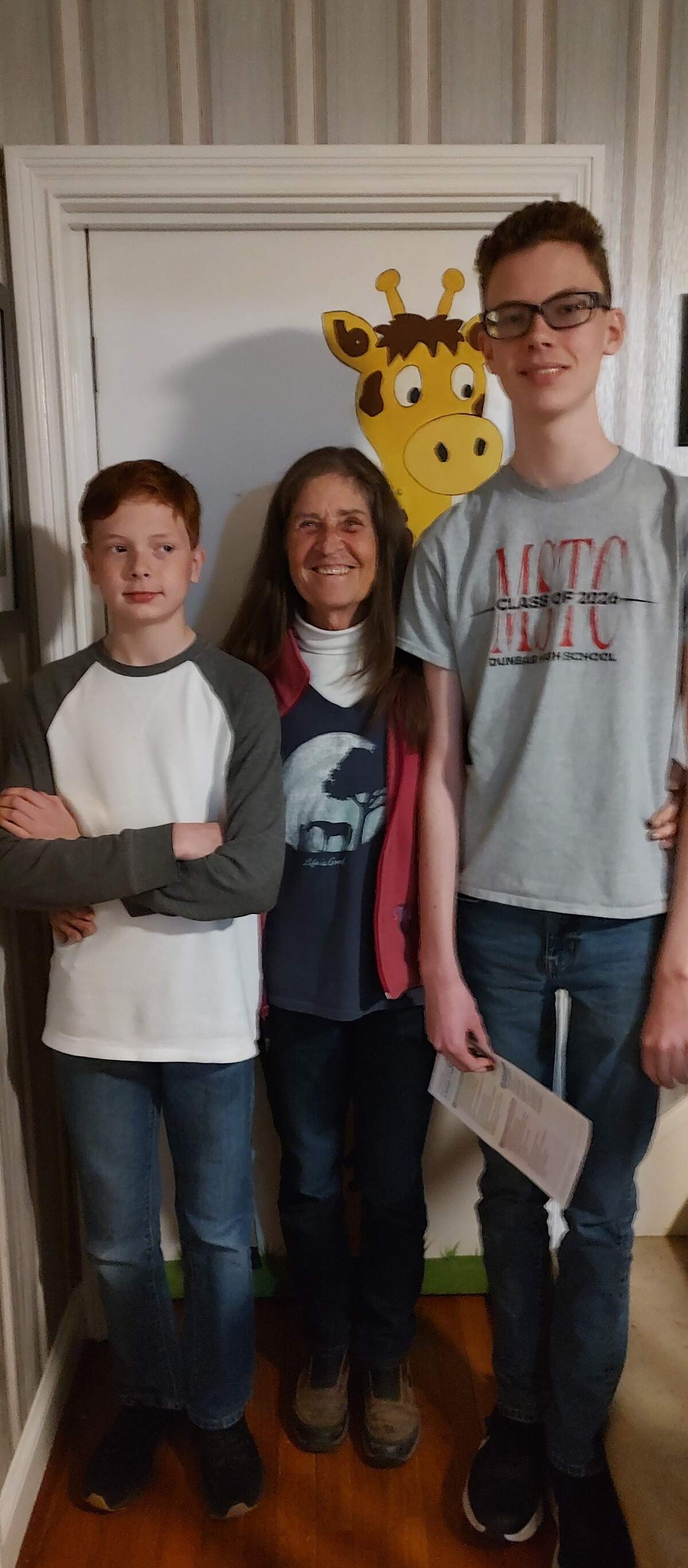Dr. Rebecca Bosomworth was photographed in front of her giraffe door with patients Caleb and Christopher Ward at her home office in Lexington, KY.