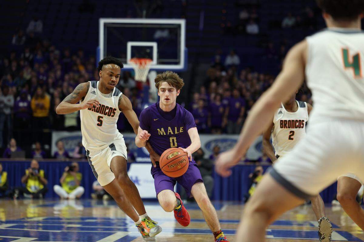 Cole Edelen of Male (0) operated against Tylon Webb (5) of Frederick Douglass on Friday night. Edelen led Male with 17 points.