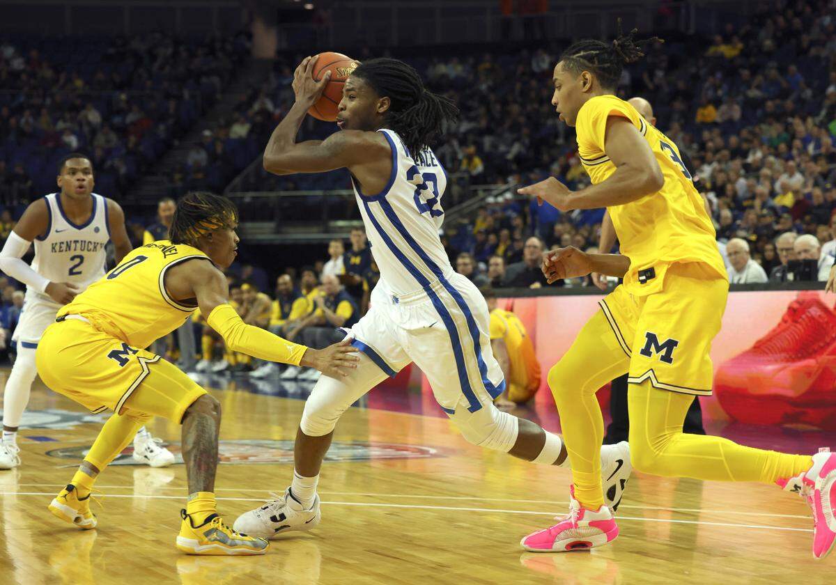 Kentucky’s Cason Wallace (22) drives past Michigan’s Dug McDaniel (0) during Sunday’s game at the O2 Arena in London.