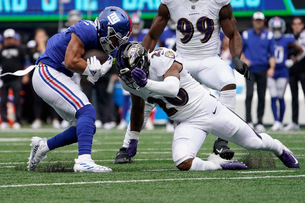 Baltimore Ravens’ Geno Stone (26) tackles New York Giants’ Wan’Dale Robinson (17) during the first half of an NFL football game Sunday, Oct. 16, 2022, in East Rutherford, N.J.