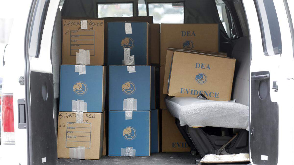 During  Wednesday's raid at  Lexington Algiatry, a pain clinic on  Alexandria Drive,  authorities  collected boxes of  evidence.         