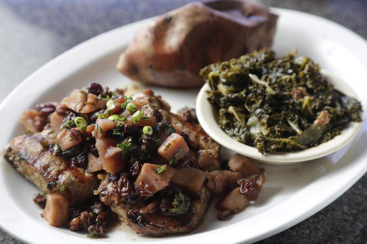 Winchell’s Maker’s Mark marinated pork chops, served with baked sweet potato and kale greens.