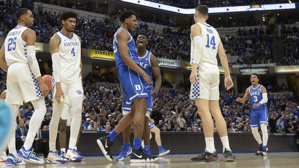 Duke center Marques Bolden (20) celebrated with teammates Zion Williamson (1) and Tre Jones (3) after he was fouled on a reverse lay-up in the first half. Duke defeated Kentucky 118-84 in the 2018-19 Champions Classic at Bankers Life Fieldhouse in Indianapolis.