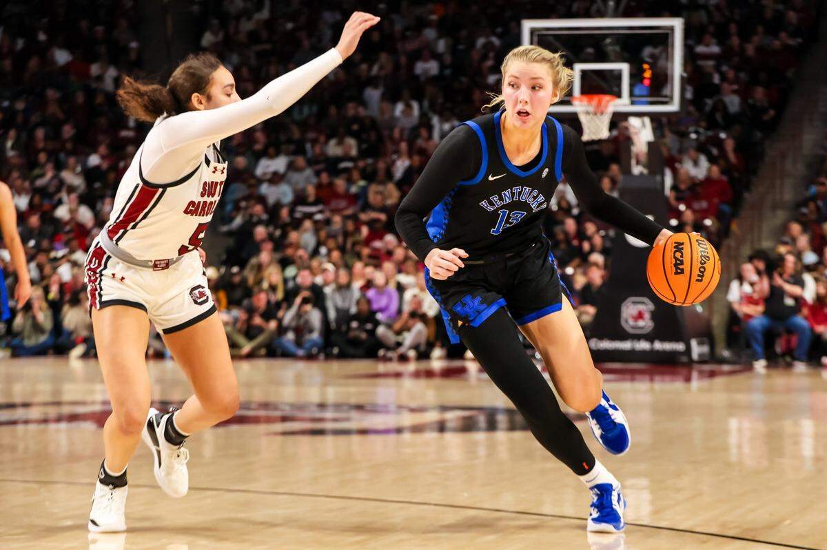 Mar 2, 2025; Columbia, South Carolina, USA; Kentucky Wildcats center Clara Strack (13) drives past South Carolina Gamecocks guard Tessa Johnson (5) in the second half at Colonial Life Arena. Mandatory Credit: Jeff Blake-Imagn Images