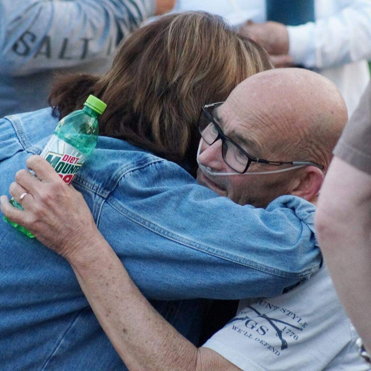 Locals gather at a prayer event for the Stanford, Ky., mayor outside his home.
