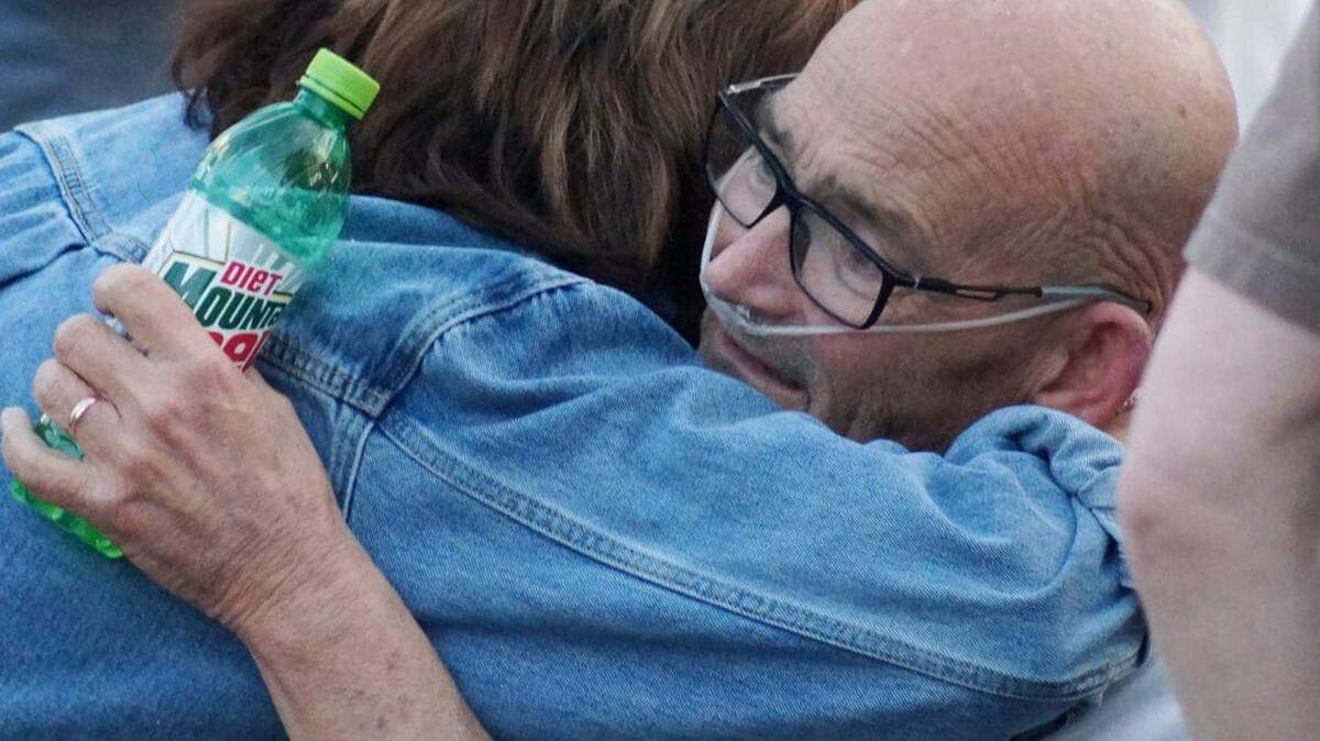 Locals gather at a prayer event for the Stanford, Ky., mayor outside his home.
