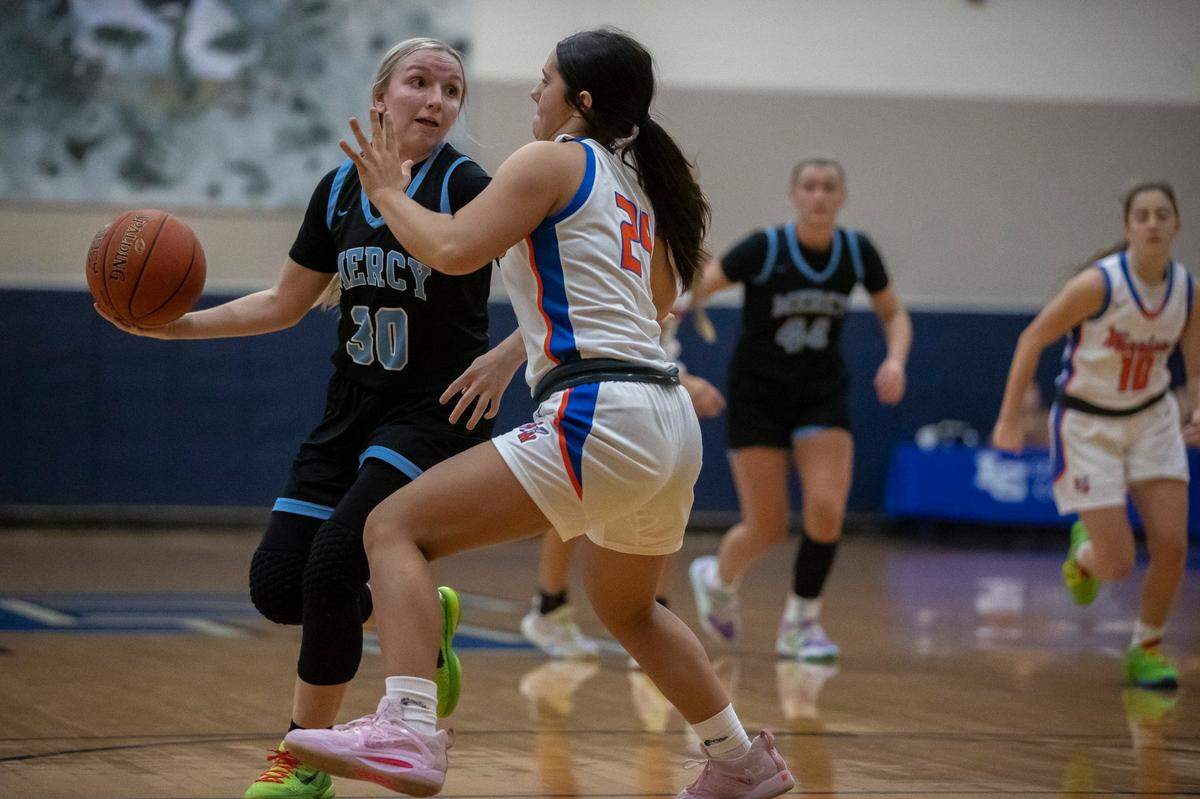 Mercy’s Alyssa Murphy (30) looks to pass the ball against Southwestern at the White, Greer & Maggard Holiday Classic at Lexington Catholic on Dec. 20, 2022.