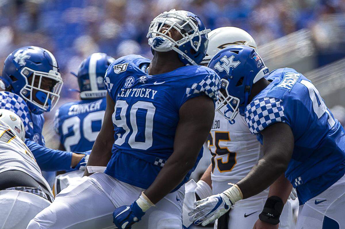 Kentucky senior defensive end T.J. Carter (90) celebrated after sacking Toledo QB Mitchell Guadagni during UK’s 38-24 win last week.