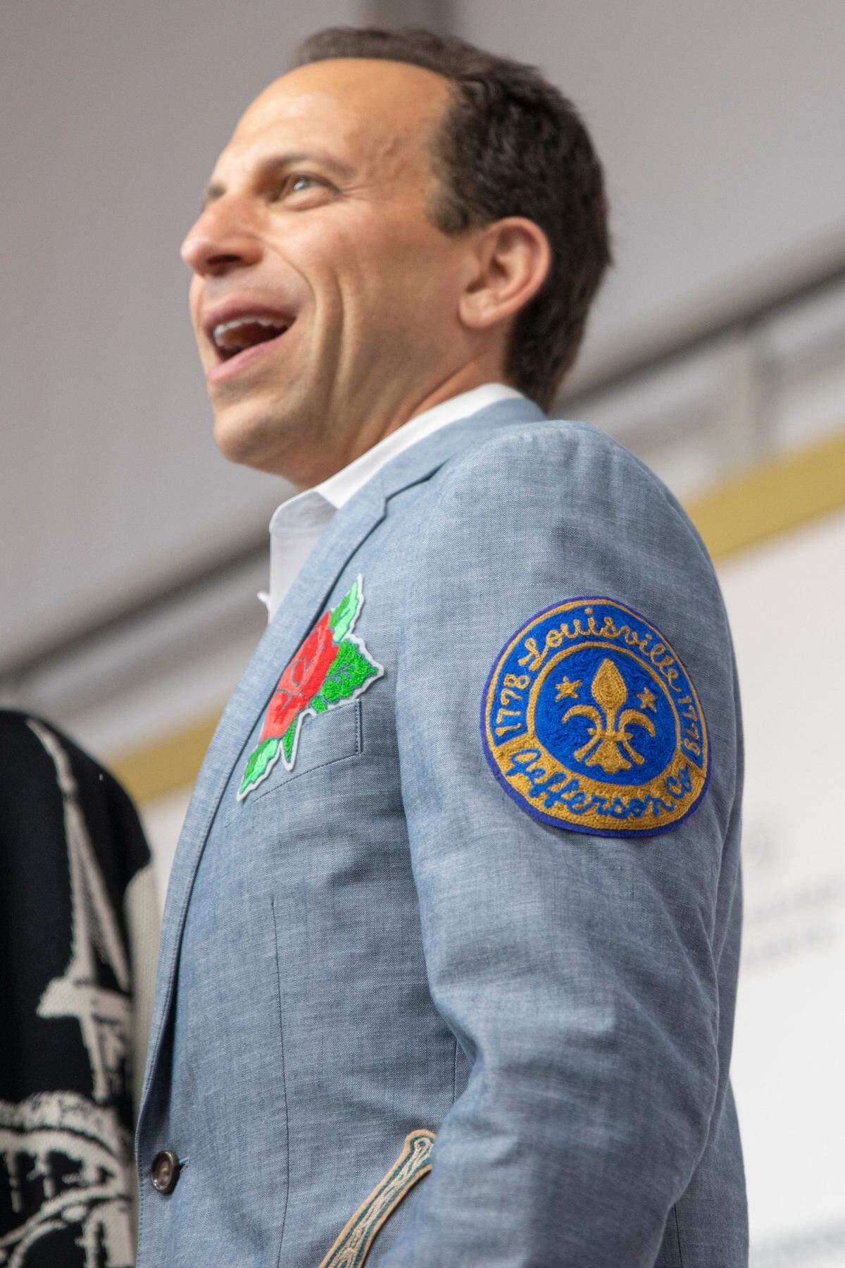 Louisville Mayor Craig Greenberg shows off the patches on his suit jacket on the red carpet at Churchill Downs before the start of 149th Kentucky Derby in Louisville, Kentucky on Saturday, May 6, 2023. He says a friend made the piece for him.