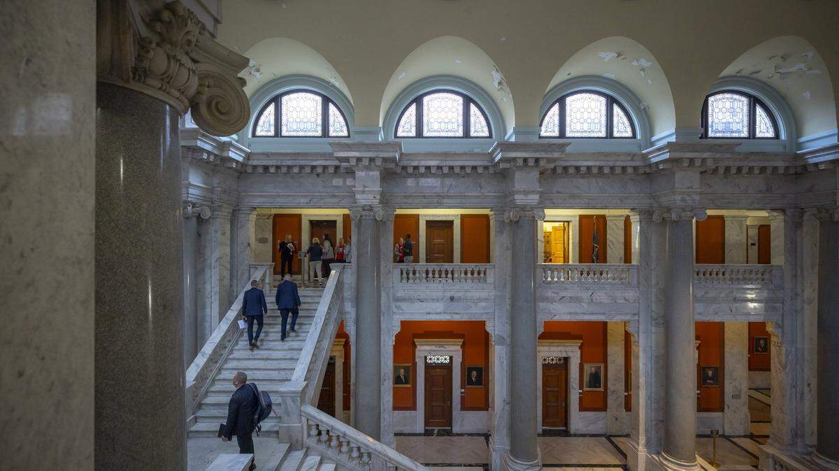 Legislators and visitors walk up the steps to the Senate chambers at the Kentucky state Capitol in Frankfort, Ky., on Monday, April 15, 2024.