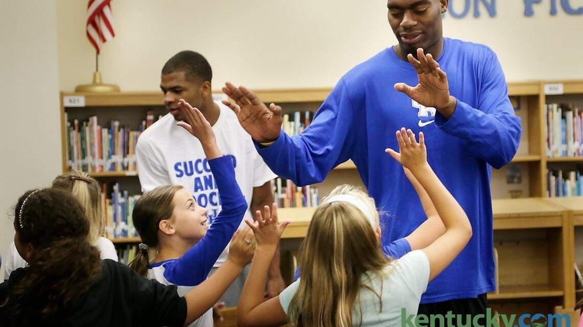 Dakari Johnson high-fived fifth-graders Thursday during a visit by Kentucky basketball players to Cassidy Elementary School in Lexington. After delivering meals from God's Pantry to the school, four players met with a class of 25 students, spoke about the importance of a college education, answered questions and posed for a group photo.