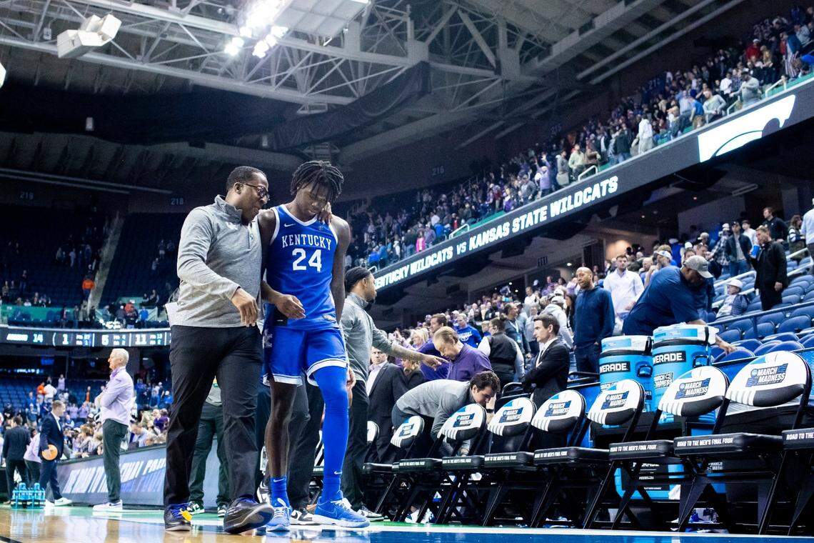 Kentucky freshman Chris Livingston walks off the court with assistant coach Chin Coleman after an NCAA Tournament loss to Kansas State on Sunday.