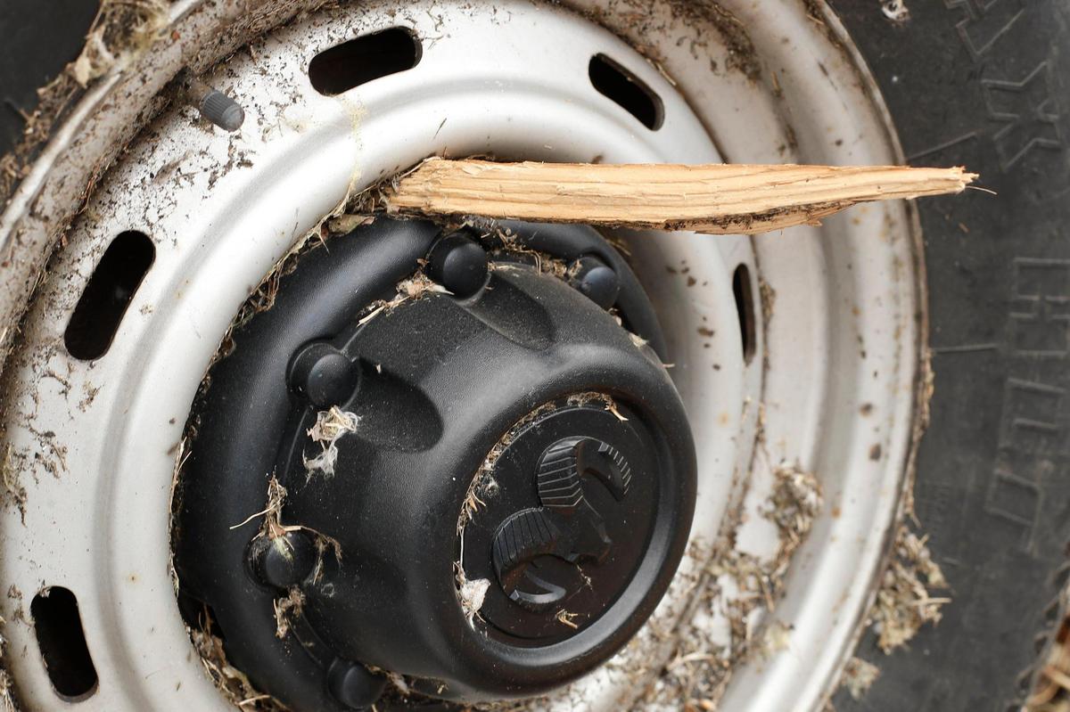 A piece of wood sits wedged in a rim of a Dodge Ram van along Mayfield’s Paducah Road.