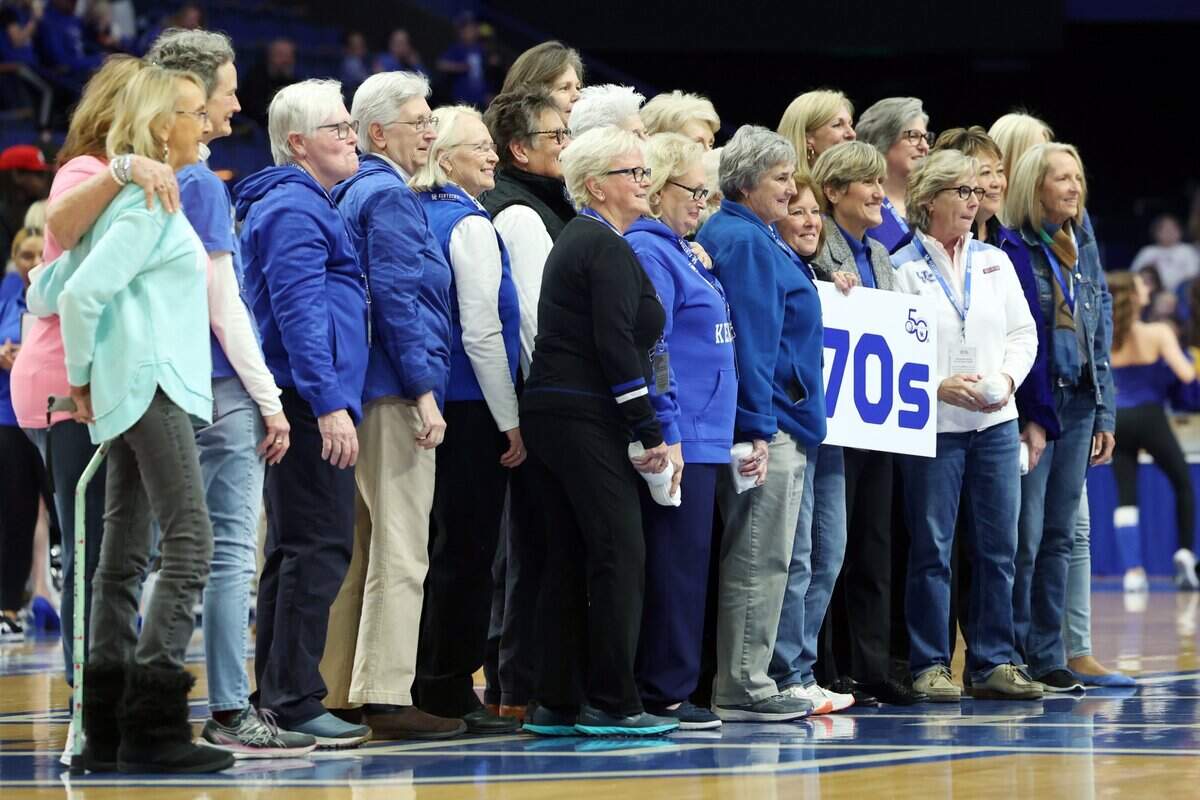 Kentucky alumni from the 1970s gather on the Rupp Arena court during Sunday’s game against Florida.