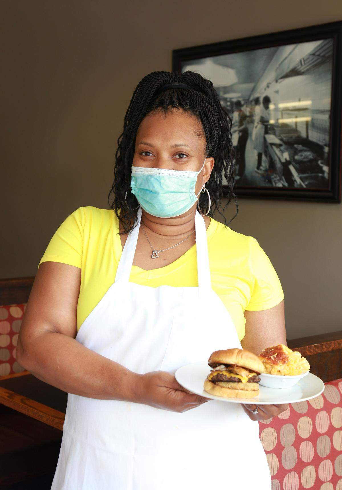 Josanne’s Homestyle kitchen owner Tamara Hall with the Southern Love Burger, featuring a patty topped with Cajun deep-fried turkey, fried green tomato, white cheddar cheese and sweet potato mayo.