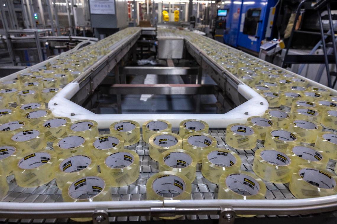 Rolls of packing tape run through a convey belt at a 3M facility in Cynthiana, Ky, on Tuesday, Sept. 24, 2024.