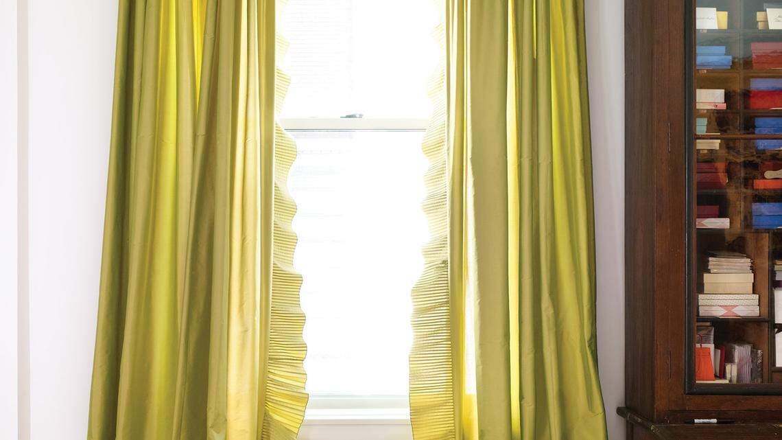 Designer-author Elizabeth Mayhew left taffeta curtains in her living room unlined so their pleated edge would ripple.