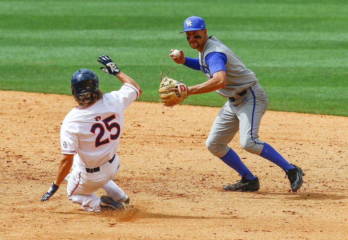 Kentucky infielder Trey Dawson (2) threw to first for the double play as Auburn outfielder Jay Estes (25) slid into second base during the fourth inning in Hoover, Ala., on Tuesday.
