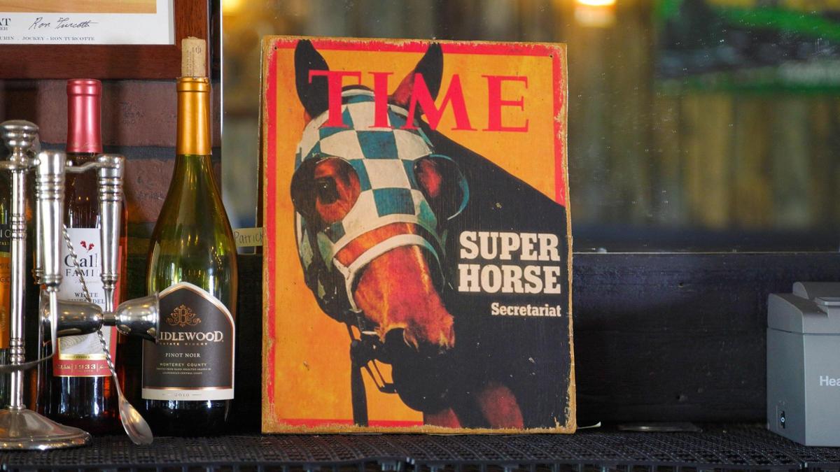 Secretariat memorabilia like this Time magizine cover are all over the interior of Golden’s Pub & Deli in Georgetown.