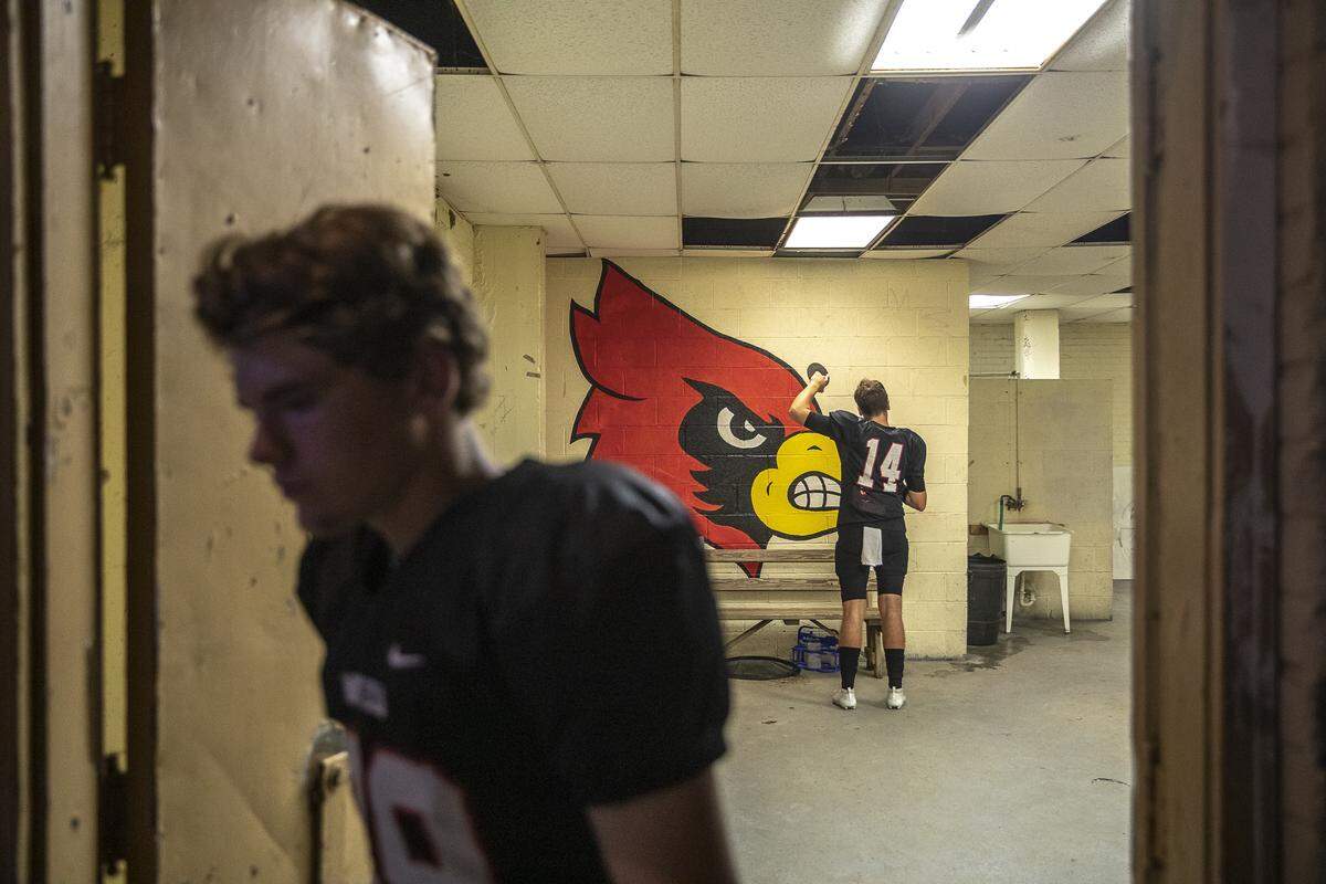 Mayfield’s Dalan Webb walks out of the Cardinals’ locker room, leaving quarterback Jayden Stinson a few moments to himself, before the start of a game against Graves County.
