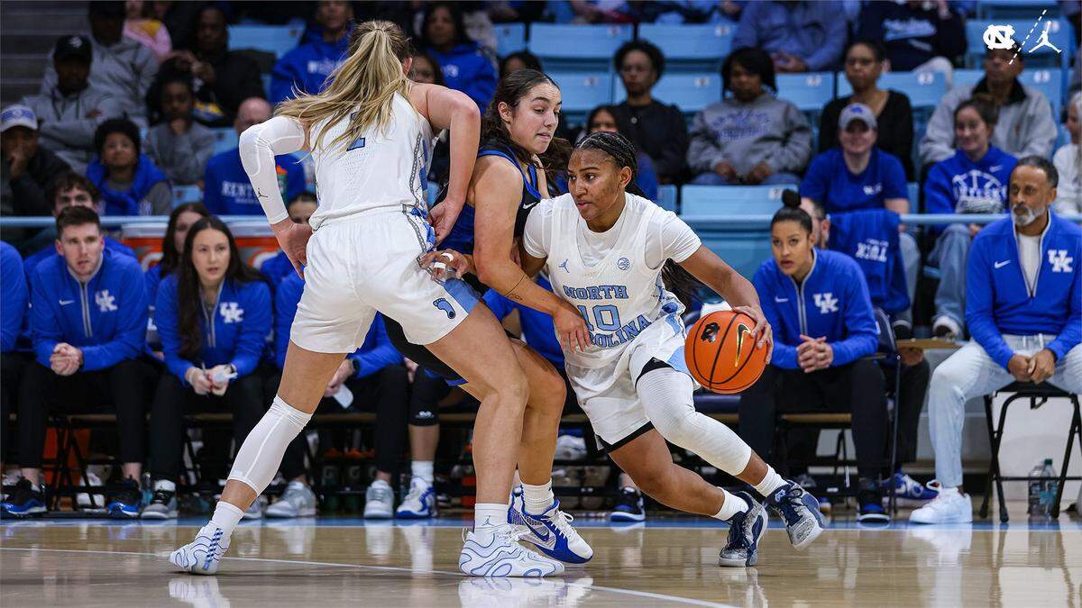 North Carolina’s Reniya Kelly (10) and Alyssa Ustby (1) put the squeeze on Kentucky defender Georgia Amoore during Thursday night’s game in Chapel Hill.