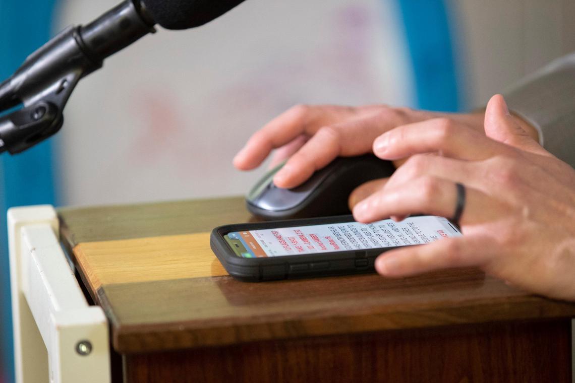 On another stack of kids’ furniture in front of him, Victor Puente has a mouse to keep his TV, behind him, from going to sleep.