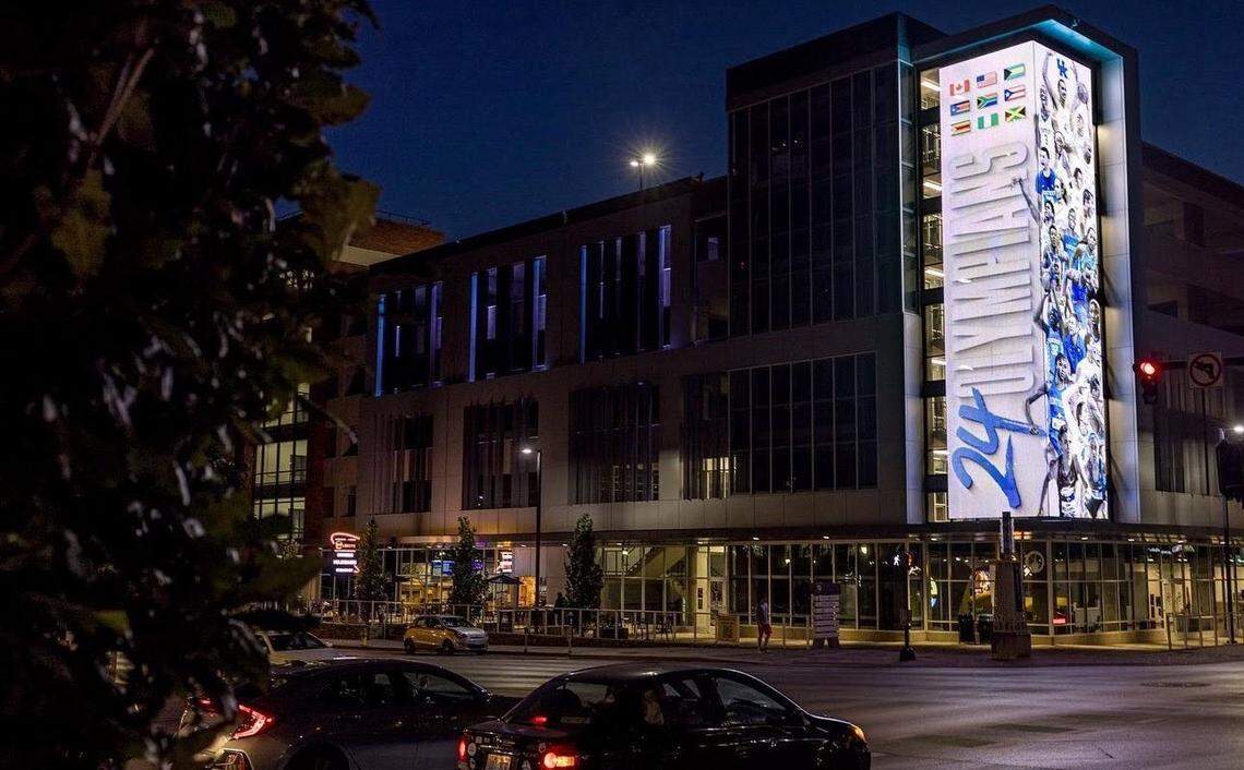 A photo provided by L8NITE Fast Food owner Mohamed Weheba shows the lighted sign, left, UK has objected to compared to the LED billboard already on the Cornerstone building.