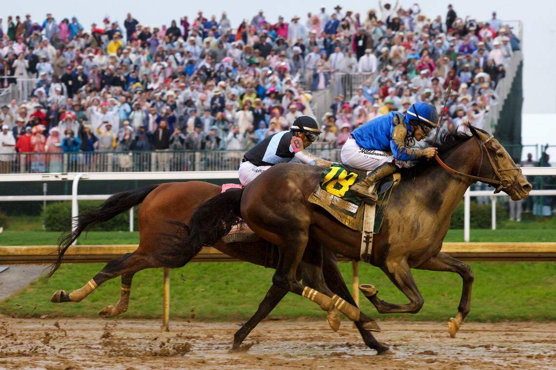 Sovereignty (18), with jockey Junior Alvarado up, passes Journalism and jockey Umberto Rispoli up in the final stretch to win the Kentucky Derby at Churchill Downs.
