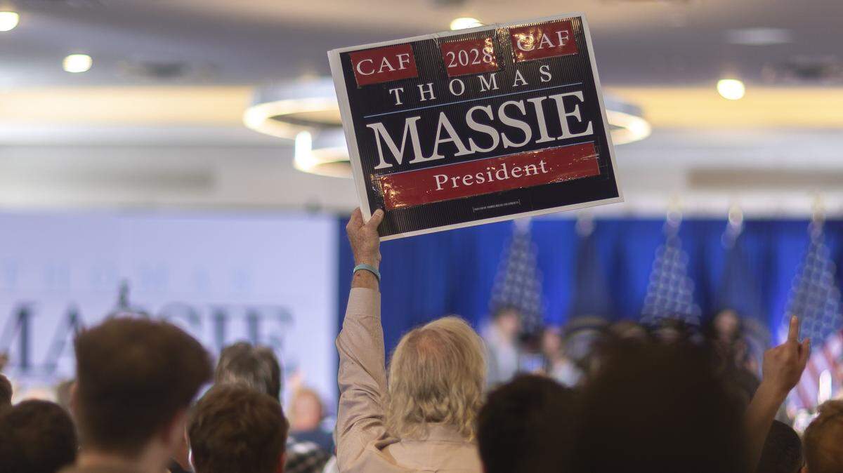 A supporter holds a sign for Rep. Thomas Massie as Massie delivers a concession speech at an election night watch party at the Marriott Cincinnati Airport in Hebron, Ky., on Tuesday, May 19, 2026.