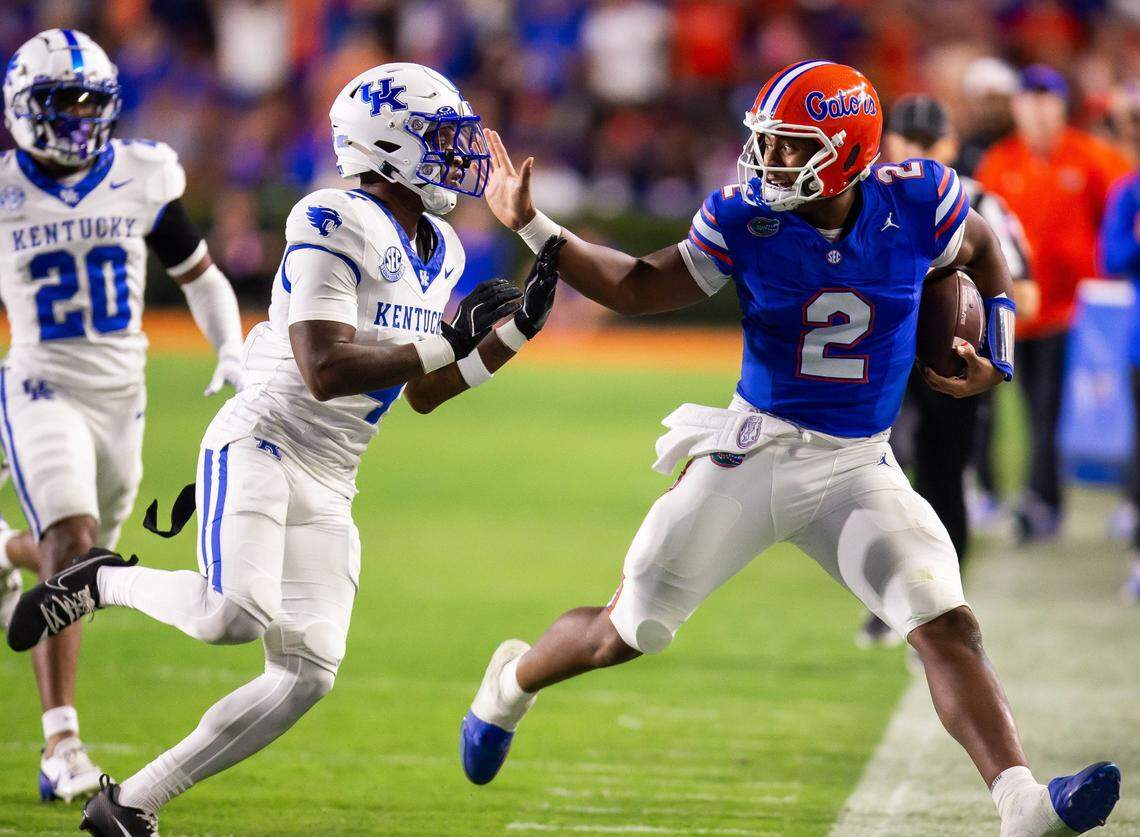 Florida Gators quarterback DJ Lagway (2) stiff arms Kentucky Wildcats defensive back Kristian Story (4) during the first half at Ben Hill Griffin Stadium in Gainesville, FL on Saturday, October 19, 2024 against the Kentucky Wildcats. [Doug Engle/Gainesville Sun]