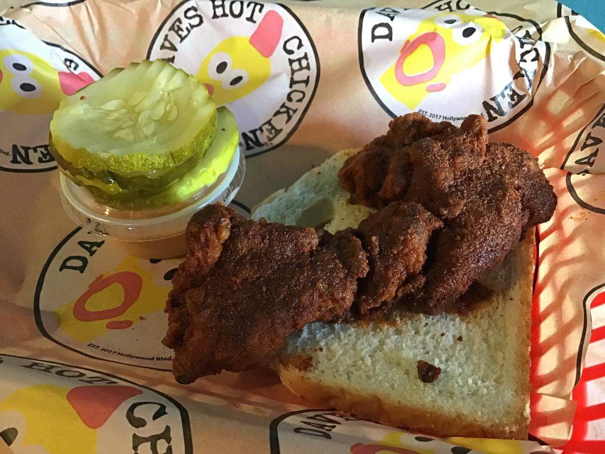 Chicken tenders can be ordered in any spice level, including “reaper,” above, which comes with a waiver to sign. Tenders are served on white bread with Dave’s sauce and pickles.