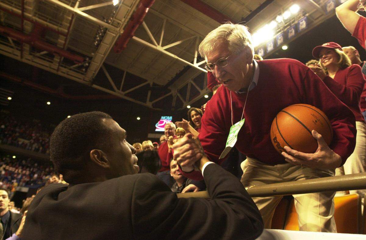 Mike Davis, left, coached Indiana to its only Final Four (2002) since the Bobby Knight era ended in 2000. After beating Kent State 81-69 in the 2002 NCAA Tournament South Region finals, Davis gave the game ball to then-IU president Myles Brand, right.