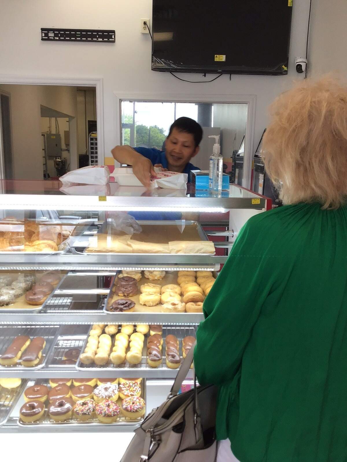 Owner and baker Narith Chea boxes up some doughnuts for a customer on July 8, 2026, at Sunrise Donuts, 565 E. New Circle Road in Lexington.