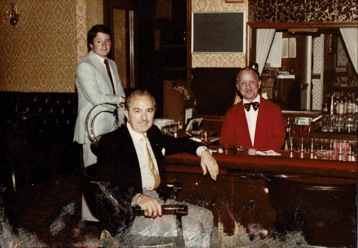 Stanley Demos, center, at the bar of his Lexington restaurant, The Coach House, in an undated photo.
