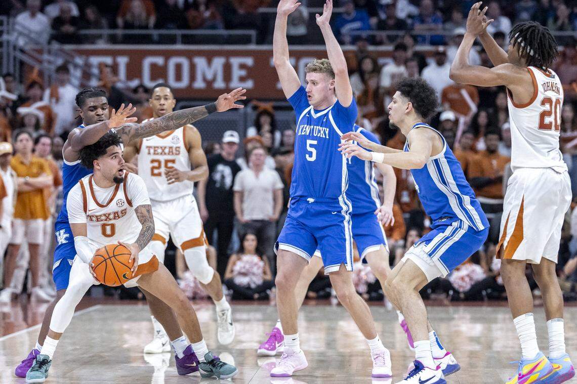 Kentucky guard Otega Oweh (00) defends as Texas guard Jordan Pope (0) looks to move the ball during Saturday’s game at the Moody Center in Austin.