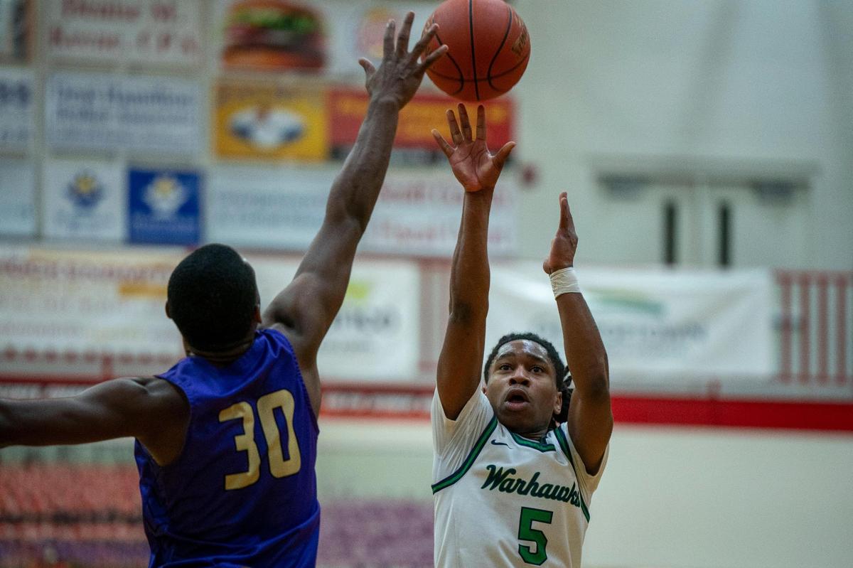 Great Crossing’s Junius Burrell (5) takes a shot over Male’s Terrence Hall (30) in the Warhawks’ 65-63 victory at Scott County High School.
