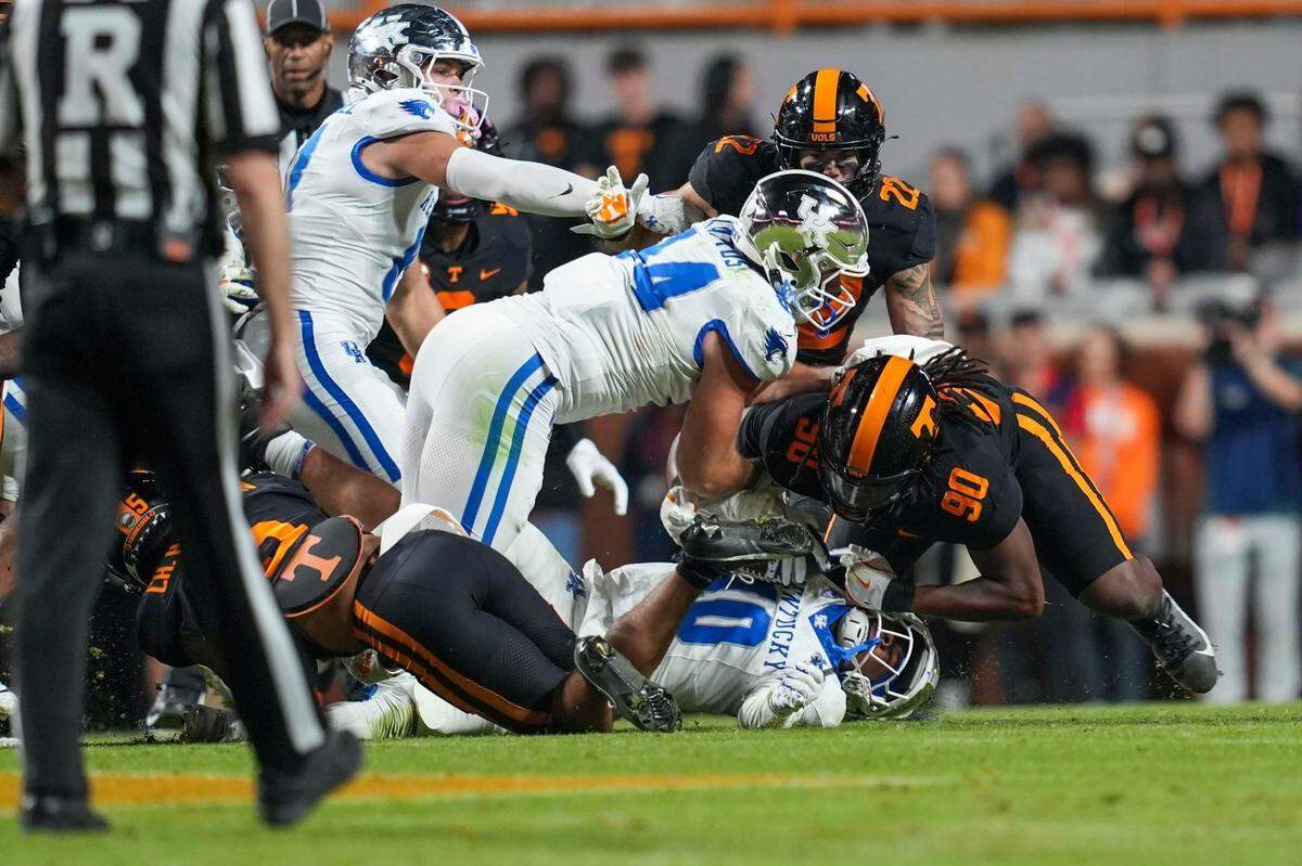 Tennessee defensive lineman Dominic Bailey (90) tackles Kentucky running back Jamarion Wilcox (10) during a NCAA football game between Tennessee and Kentucky in Neyland Stadium on Saturday, Nov. 2, 2024.