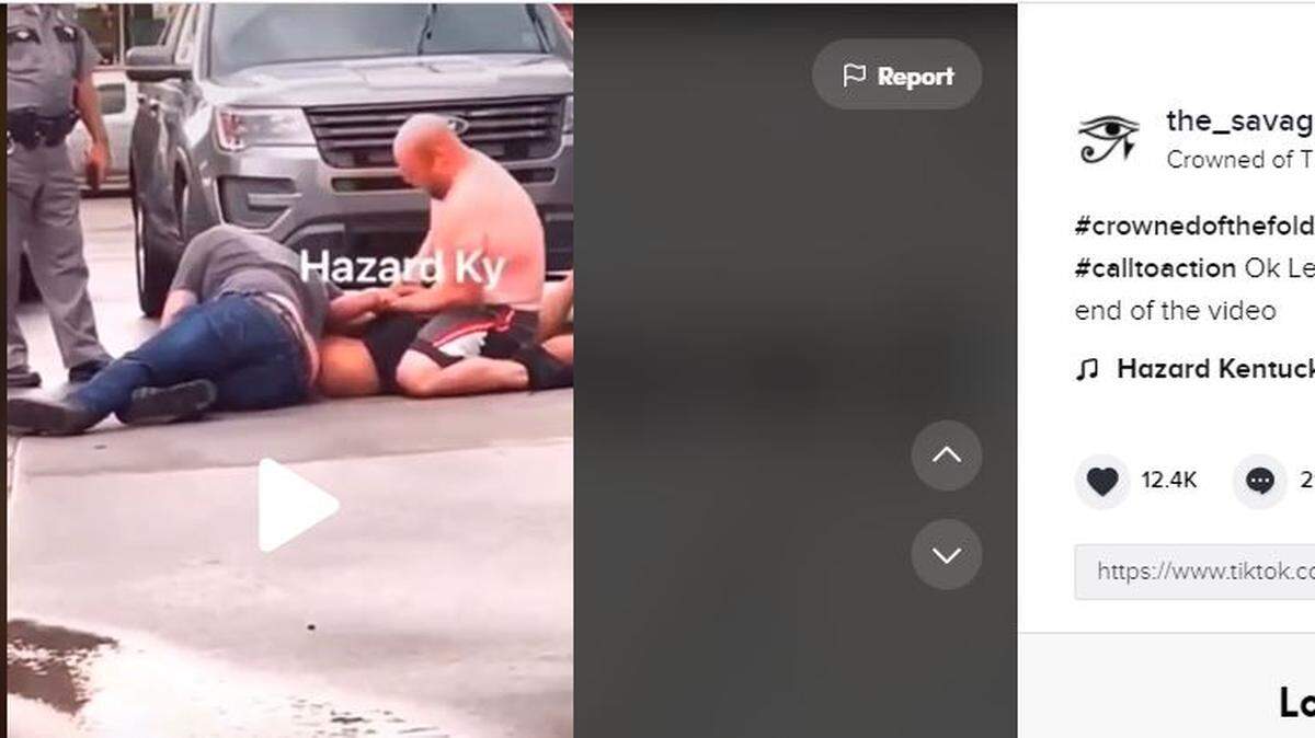 A viral video shared on TikTok Tuesday showed two men restraining a third man while a Kentucky State Police trooper watched.