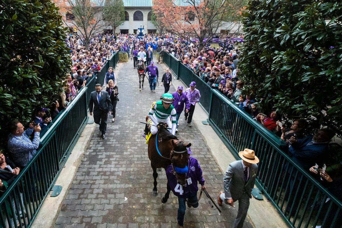 Flightline, with jockey Flavien Prat, exits the paddock before winning the Breeders’ Cup Classic at Keeneland in 2022.