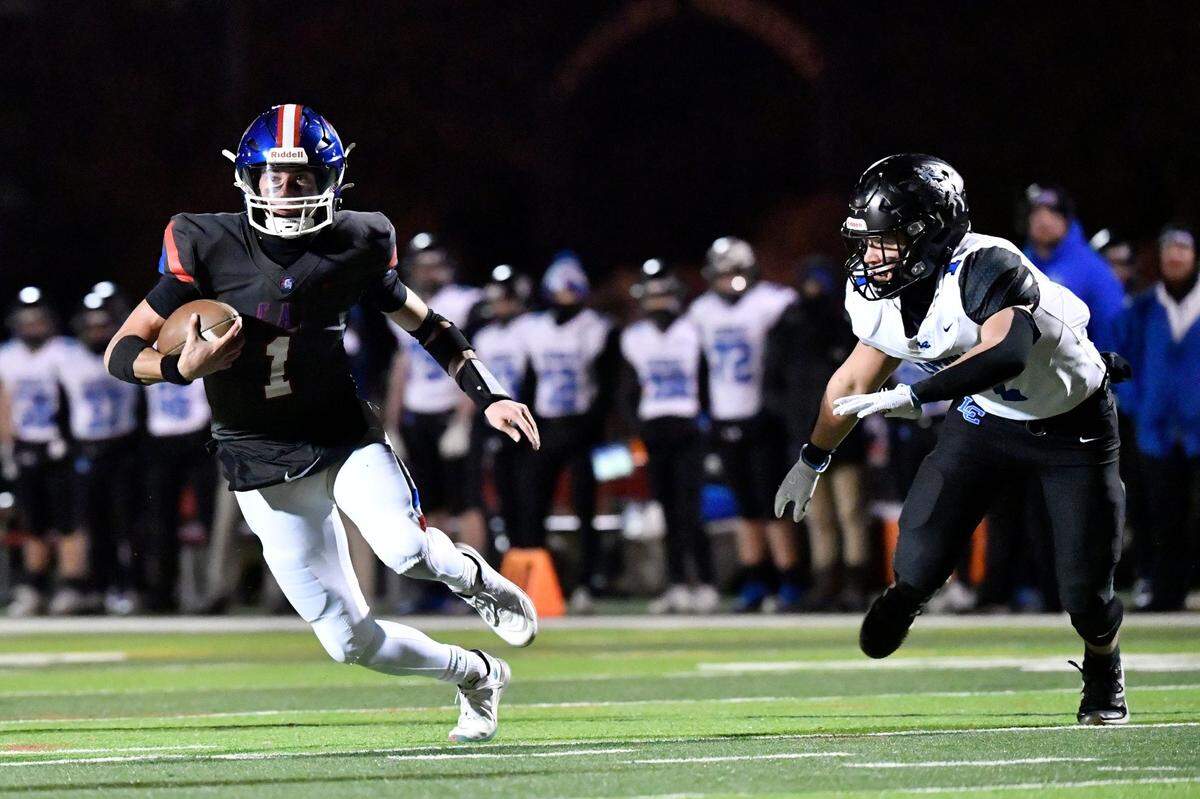 Christian Academy's Connor Hodge (1), left, runs from the pursuit of Lexington Catholic's Brady Wasik (1) during the first half of their KHSAA 3A football game, Friday, Nov. 29 2024 in Louisville Ky.