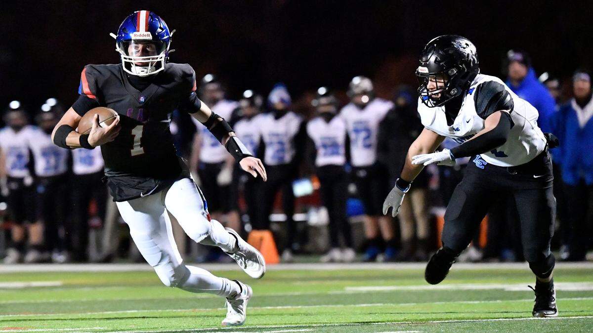Christian Academy's Connor Hodge (1), left, runs from the pursuit of Lexington Catholic's Brady Wasik (1) during the first half of their KHSAA 3A football game, Friday, Nov. 29 2024 in Louisville Ky.