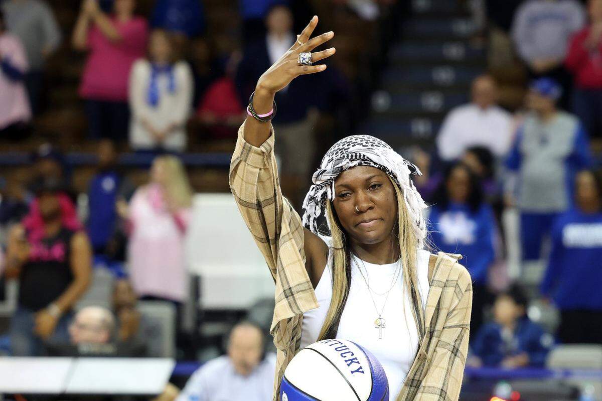 Former Kentucky great Rhyne Howard shows off her SEC Tournament championship ring from last season at halftime of the Wildcats’ game against Alabama on Thursday night.